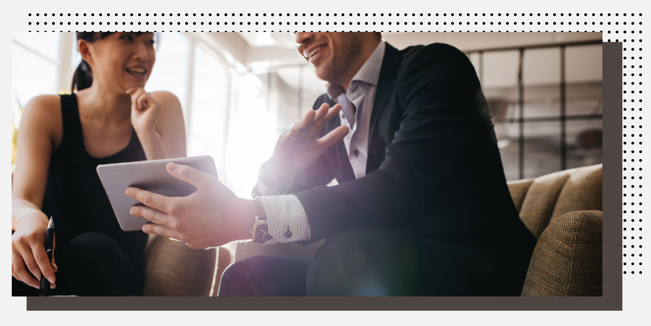 Man and woman talking over an ipad